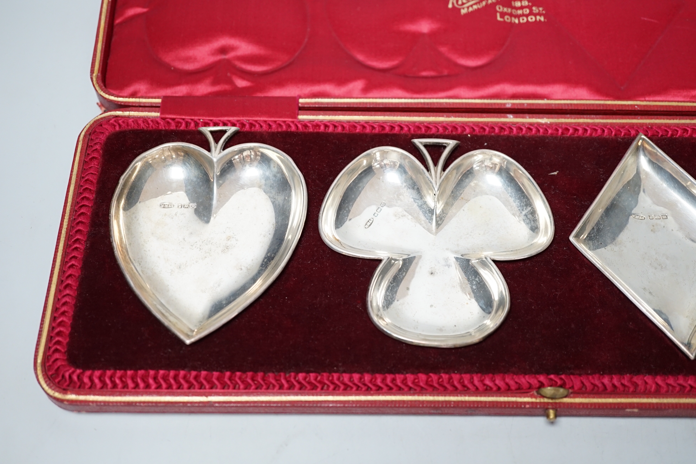 An Edwardian cased set of four novelty silver playing card suite shaped ashtrays, William Mammatt & Son, Sheffield, 1904, heart dish 94mm.